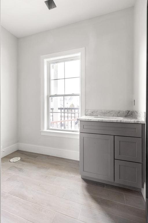 interior space with light wood-type flooring and baseboards