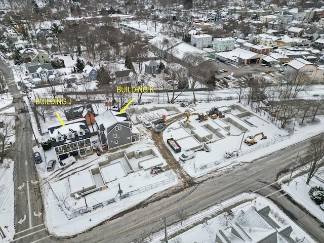 snowy aerial view with a residential view