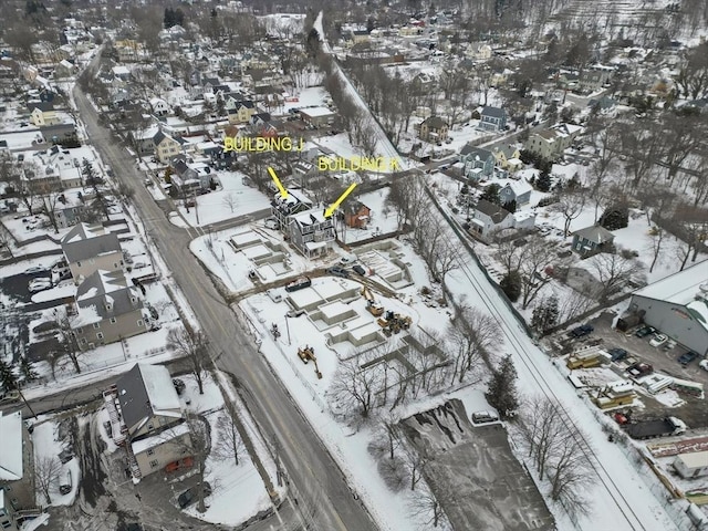 snowy aerial view featuring a residential view