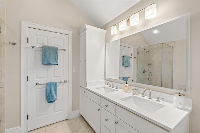 49 Intrepid Cir Unit 49, Marblehead, MA 01945 - bathroom with vaulted ceiling, a stall shower, double vanity, and baseboards