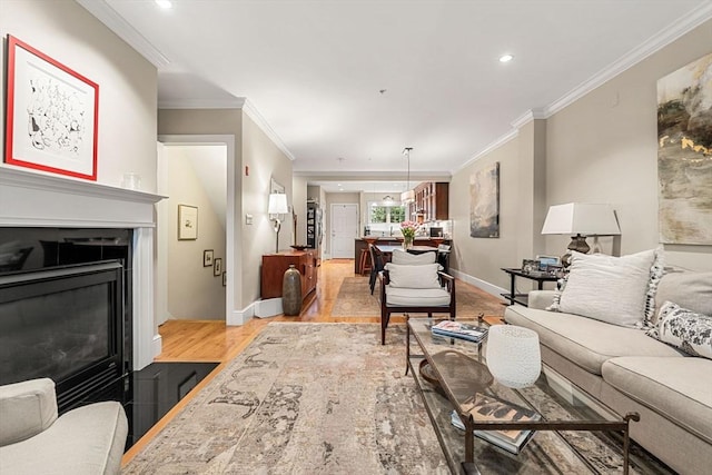 49 Intrepid Cir Unit 49, Marblehead, MA 01945 - living area featuring light wood-style flooring, crown molding, recessed lighting, baseboards, and a fireplace with flush hearth
