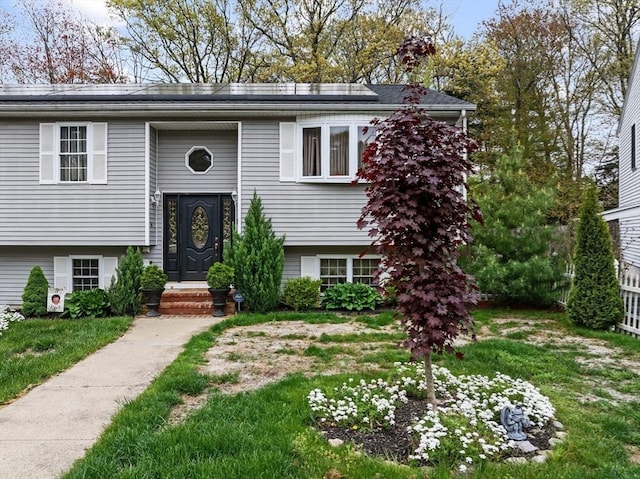 64 Ventura Ln, New Bedford, MA 02745 - split foyer home with roof mounted solar panels and a front lawn
