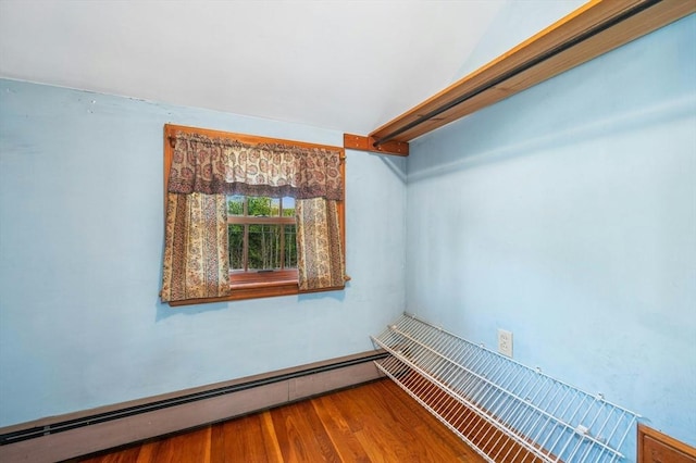 walk in closet featuring wood finished floors and a baseboard radiator