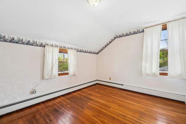 bonus room featuring vaulted ceiling, a baseboard heating unit, and hardwood / wood-style floors