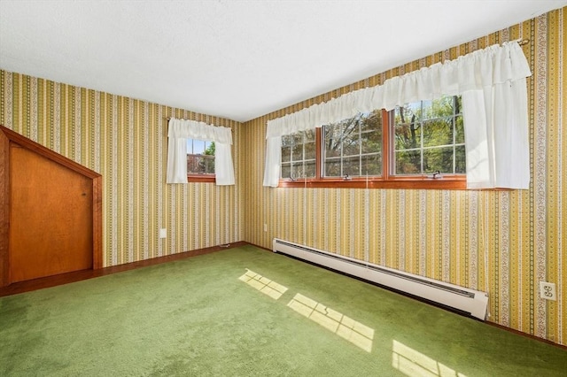 spare room featuring carpet floors, a baseboard radiator, and wallpapered walls