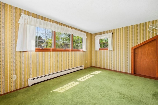 carpeted empty room featuring a baseboard radiator and wallpapered walls