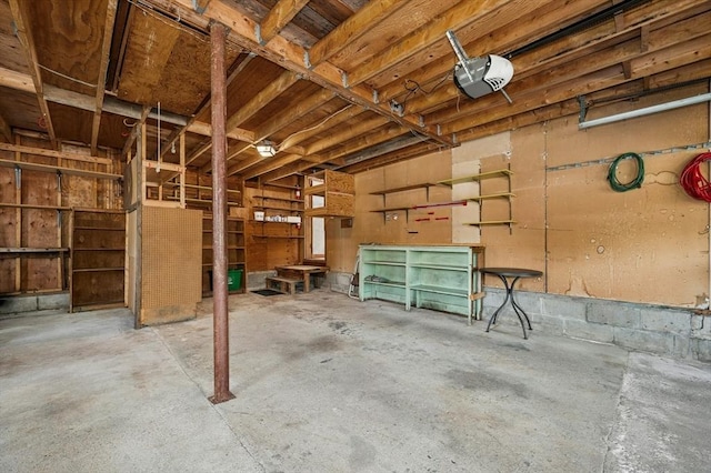 garage featuring a garage door opener and a workshop area