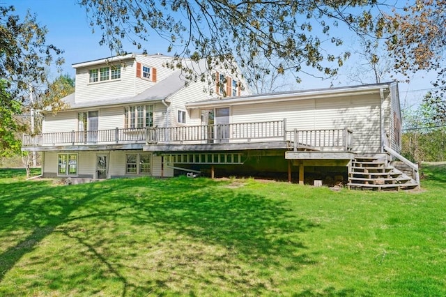back of house with a lawn, stairway, and a deck