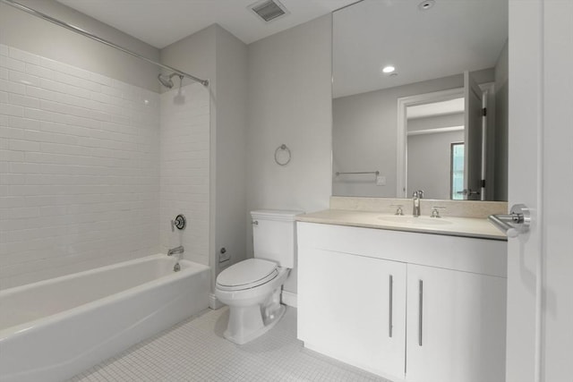 full bathroom with tile patterned flooring, vanity, tiled shower / bath combo, and toilet