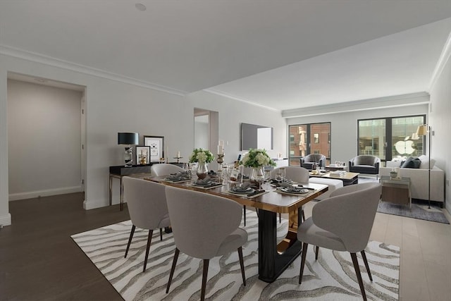 dining space with hardwood / wood-style floors and crown molding