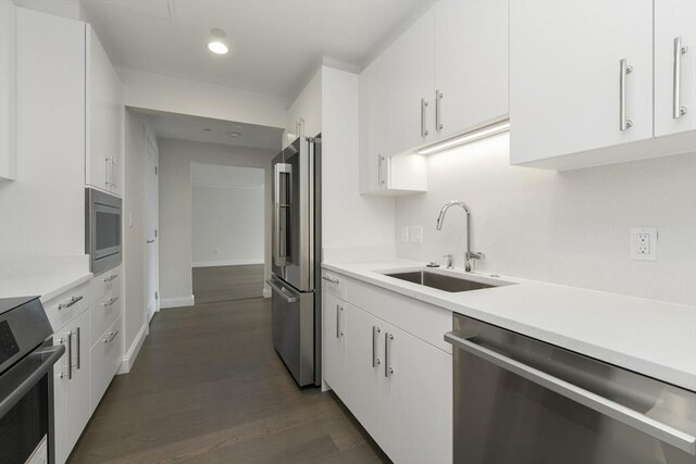 kitchen featuring sink, white cabinetry, and stainless steel appliances