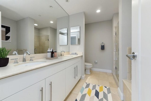 bathroom featuring tile patterned flooring, vanity, toilet, and a shower with shower door