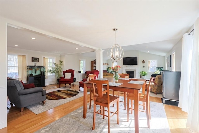 585 Chestnut St, Ashland, MA 01721 - dining room featuring a fireplace, recessed lighting, lofted ceiling, and light wood-type flooring