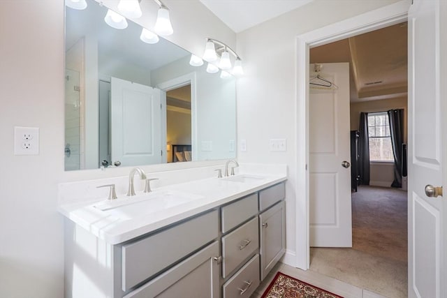 585 Chestnut St, Ashland, MA 01721 - bathroom with double vanity, a sink, and baseboards