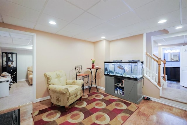 585 Chestnut St, Ashland, MA 01721 - sitting room with wood finished floors, stairway, recessed lighting, baseboards, and a paneled ceiling