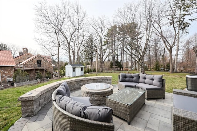 585 Chestnut St, Ashland, MA 01721 - view of patio featuring an outdoor structure, an outdoor living space with a fire pit, a storage unit, and cooling unit