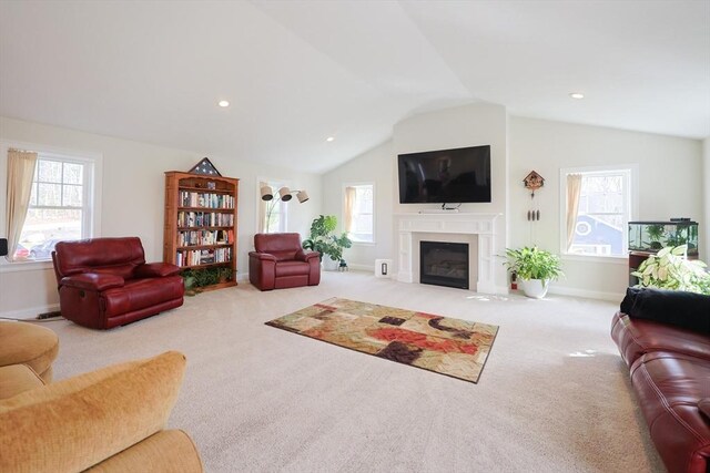 585 Chestnut St, Ashland, MA 01721 - carpeted living room featuring a fireplace with flush hearth, baseboards, lofted ceiling, and a healthy amount of sunlight