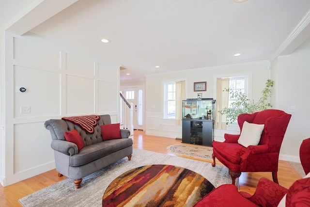 585 Chestnut St, Ashland, MA 01721 - living area with a decorative wall, crown molding, recessed lighting, and light wood-type flooring
