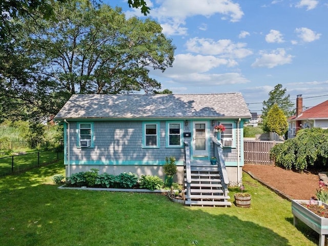 13 Elcott Rd, Quincy, MA 02169 - view of front of house featuring a fenced backyard, a shingled roof, and cooling unit