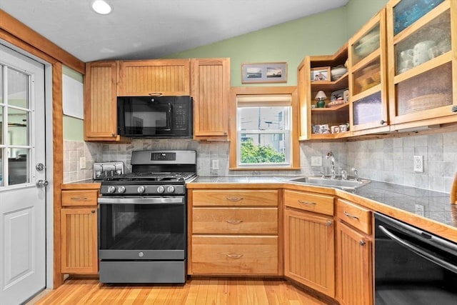 13 Elcott Rd, Quincy, MA 02169 - kitchen featuring black appliances, vaulted ceiling, light wood-type flooring, and decorative backsplash