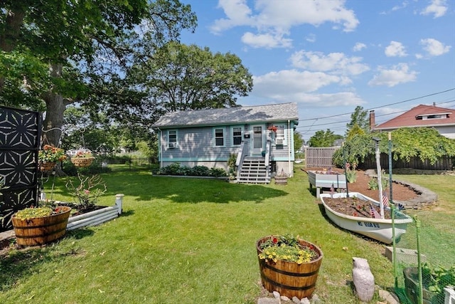 13 Elcott Rd, Quincy, MA 02169 - rear view of property with a vegetable garden