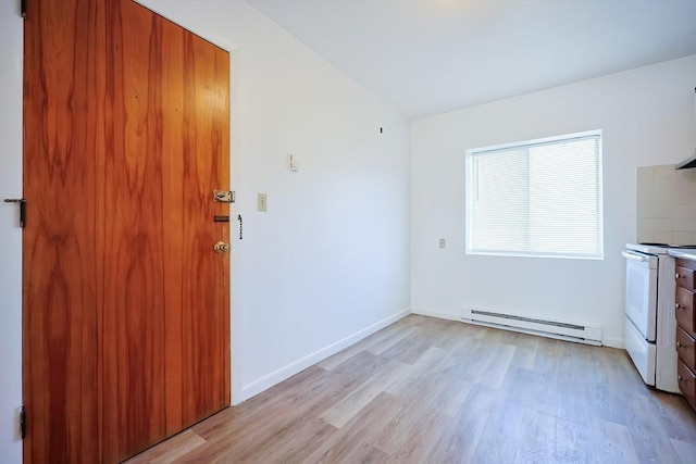 interior space with light wood finished floors, baseboards, white range with electric cooktop, and a baseboard radiator