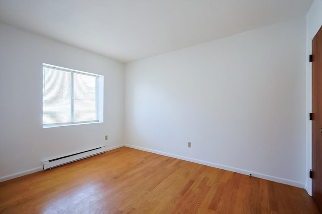 unfurnished room featuring light wood-type flooring, a baseboard radiator, and baseboards