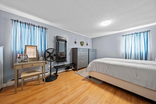 79 Fountain Unit 5, Weymouth, MA 02190 - bedroom with crown molding, baseboard heating, baseboards, and wood finished floors