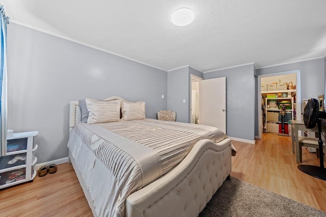 79 Fountain Unit 5, Weymouth, MA 02190 - bedroom with crown molding, baseboards, and light wood-style flooring