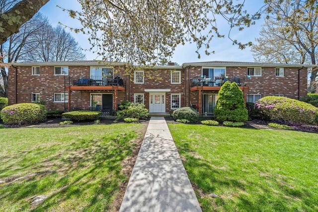 79 Fountain Unit 5, Weymouth, MA 02190 - townhome / multi-family property featuring brick siding, a balcony, and a front lawn