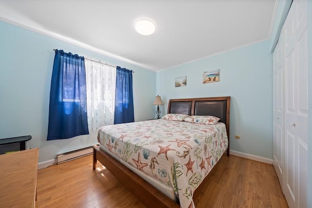 79 Fountain Unit 5, Weymouth, MA 02190 - bedroom with a closet, ornamental molding, wood finished floors, baseboards, and a baseboard heating unit