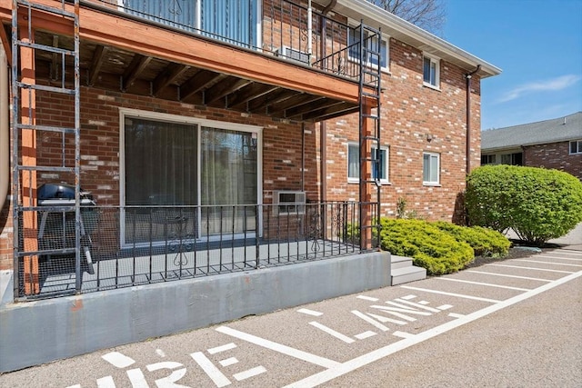 79 Fountain Unit 5, Weymouth, MA 02190 - doorway to property featuring brick siding, uncovered parking, and a balcony