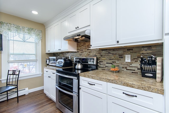 kitchen featuring dark wood-type flooring, range with two ovens, decorative backsplash, baseboard heating, and white cabinetry