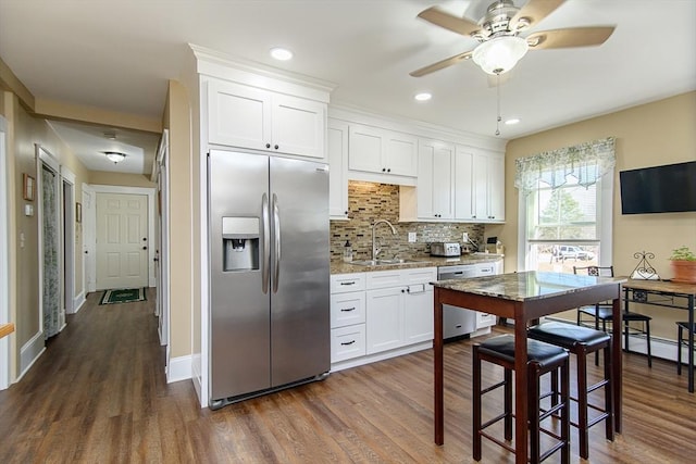 191 Providence St, Putnam, CT 06260 - kitchen featuring appliances with stainless steel finishes, dark wood-type flooring, backsplash, and recessed lighting