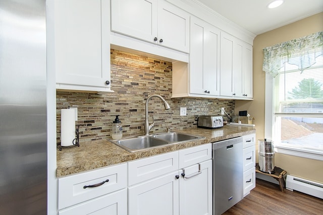 kitchen with sink, white cabinets, a baseboard radiator, and appliances with stainless steel finishes