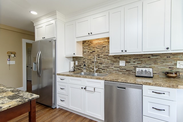 kitchen featuring appliances with stainless steel finishes, white cabinetry, dark wood-type flooring, and sink