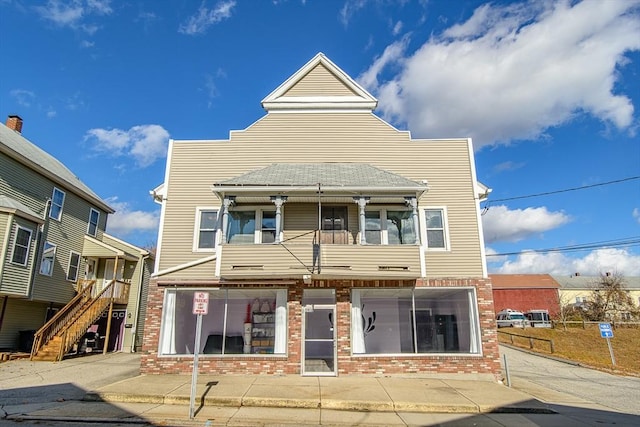 191 Providence St, Putnam, CT 06260 - view of property with brick siding, a balcony, and stairway