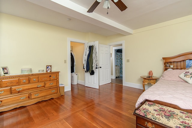 bedroom featuring a closet, hardwood / wood-style flooring, a spacious closet, and ceiling fan