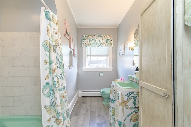 bathroom featuring walk in shower, ornamental molding, sink, hardwood / wood-style flooring, and a baseboard radiator