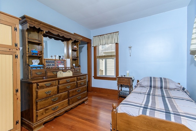 bedroom with dark wood-type flooring