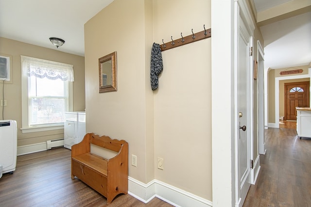 corridor featuring dark wood-type flooring and a baseboard heating unit