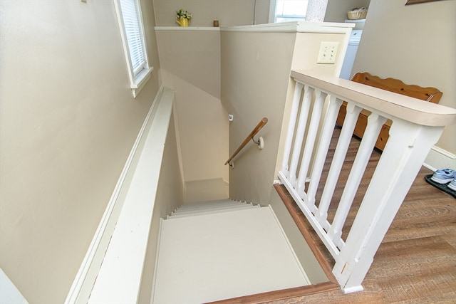 stairway featuring wood-type flooring