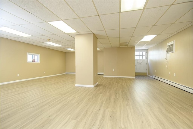 191 Providence St, Putnam, CT 06260 - below grade area featuring a baseboard heating unit, light wood-style flooring, a paneled ceiling, a wall mounted air conditioner, and plenty of natural light
