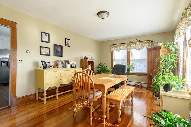 dining area featuring wood-type flooring and a baseboard radiator