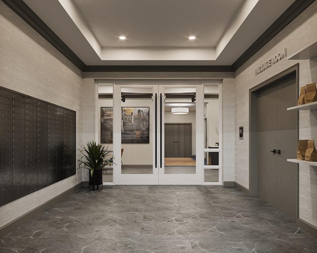 interior space with a mail area and a tray ceiling