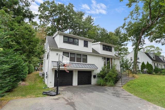 view of front of house with a garage and a front yard