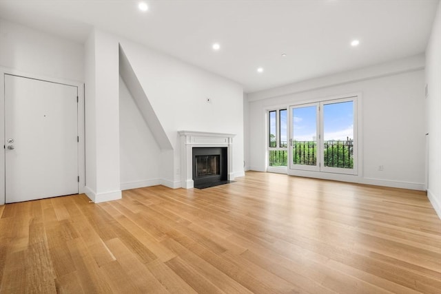 2 Clarendon St Unit 510, Boston, MA 02116 - unfurnished living room featuring light wood-type flooring, recessed lighting, a fireplace with flush hearth, and baseboards