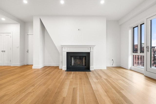 2 Clarendon St Unit 510, Boston, MA 02116 - unfurnished living room with recessed lighting, light wood-style flooring, a fireplace with flush hearth, and baseboards