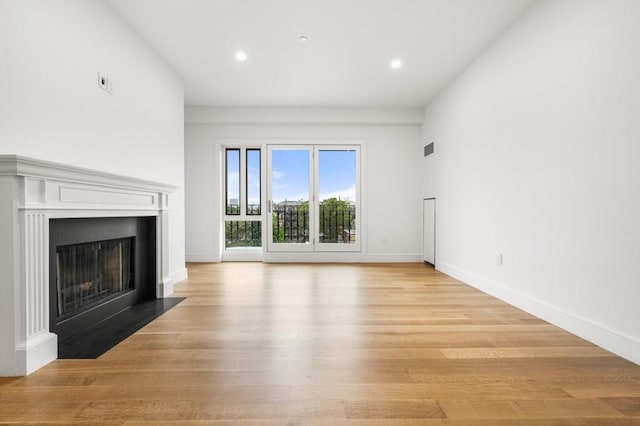 2 Clarendon St Unit 510, Boston, MA 02116 - unfurnished living room with a fireplace with flush hearth, light wood-type flooring, recessed lighting, and baseboards
