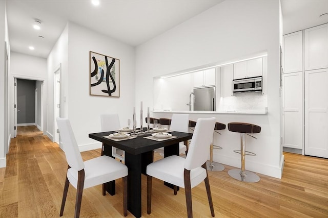 2 Clarendon St Unit 510, Boston, MA 02116 - dining area featuring light wood-style floors, baseboards, and recessed lighting